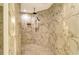 Spacious walk-in shower with marble tile and dual shower heads at 415 L Ambiance Dr # A401, Longboat Key, FL 34228