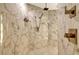 Large walk-in shower with marble tile and rainfall shower head at 415 L Ambiance Dr # A401, Longboat Key, FL 34228