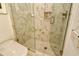 Elegant shower with marble tile and glass enclosure at 415 L Ambiance Dr # A401, Longboat Key, FL 34228