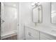 Elegant bathroom with double vanity, quartz countertops and a walk-in shower at 4238 Marina View Way, Cortez, FL 34215