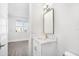 Modern bathroom with white vanity, quartz countertop, and a large mirror at 4238 Marina View Way, Cortez, FL 34215