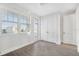 Bright bedroom featuring hardwood floors and double doors leading to a balcony at 4238 Marina View Way, Cortez, FL 34215