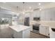 Modern kitchen with white cabinets, stainless steel appliances, and an island at 4238 Marina View Way, Cortez, FL 34215