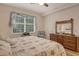 Bright bedroom featuring a comfortable queen-size bed and ample dresser space at 4250 Players Pl # 2615, Sarasota, FL 34238