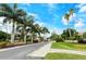 Gated community entrance with lush landscaping and palm trees at 4250 Players Pl # 2615, Sarasota, FL 34238