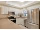 Modern kitchen with stainless steel appliances and white cabinets at 4250 Players Pl # 2615, Sarasota, FL 34238