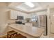 Modern kitchen featuring stainless steel appliances and an L-shaped counter at 4250 Players Pl # 2615, Sarasota, FL 34238