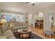 Living room with hardwood floors, striped couches, and a view of the kitchen at 4250 Players Pl # 2615, Sarasota, FL 34238