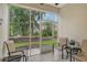 Screened patio with comfortable seating and garden view at 4250 Players Pl # 2615, Sarasota, FL 34238