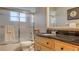 Bathroom featuring a wooden vanity with a black countertop and a sliding glass door shower at 429 N Rossetti Dr, Nokomis, FL 34275