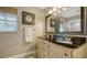 Bathroom featuring a double sink vanity with a black countertop and neutral walls at 429 N Rossetti Dr, Nokomis, FL 34275