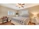 Bright bedroom featuring a ceiling fan, unique stained glass window, and a decorative sewing machine desk at 429 N Rossetti Dr, Nokomis, FL 34275