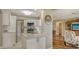 Modern kitchen featuring white cabinetry, stainless steel appliances, and quartz countertops at 429 N Rossetti Dr, Nokomis, FL 34275