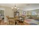 Cozy living room with wood floors, comfortable sofa, dining area, and a stained-glass window at 429 N Rossetti Dr, Nokomis, FL 34275