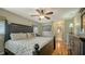 Main bedroom boasts a large bed, hardwood floors, and an en-suite bathroom at 429 N Rossetti Dr, Nokomis, FL 34275