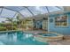 Inviting screened-in pool and jacuzzi, adjacent to patio and lush backyard at 429 N Rossetti Dr, Nokomis, FL 34275