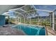 Beautiful pool area with a connected jacuzzi and covered enclosure at 429 N Rossetti Dr, Nokomis, FL 34275