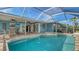 Inviting pool and spa with screened enclosure and brick patio, perfect for outdoor entertaining at 429 N Rossetti Dr, Nokomis, FL 34275