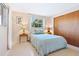 Charming bedroom with light blue bedding and wooden closet doors at 4515 Falcon Ridge Dr, Sarasota, FL 34233