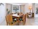 Light and airy dining room features wood table and six chairs at 4515 Falcon Ridge Dr, Sarasota, FL 34233