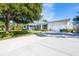 White single-story house with green shutters and a spacious driveway at 4515 Falcon Ridge Dr, Sarasota, FL 34233