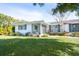 Ranch house with green lawn and mature trees at 4515 Falcon Ridge Dr, Sarasota, FL 34233