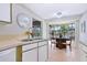 Kitchen with stainless steel sink, white cabinets, and view to backyard at 4515 Falcon Ridge Dr, Sarasota, FL 34233