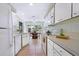 Bright kitchen features white cabinetry, modern appliances, and a sunny eat-in area at 4515 Falcon Ridge Dr, Sarasota, FL 34233