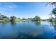 Serene lake view with homes in background at 4515 Falcon Ridge Dr, Sarasota, FL 34233