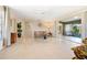 Living room with tiled floor, sliding doors to patio at 4515 Falcon Ridge Dr, Sarasota, FL 34233