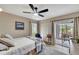 Bedroom with a queen bed and access to a screened patio at 452 Cerromar Rd # 176, Venice, FL 34293