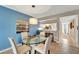 Glass-top dining table with four chairs, view of kitchen and hallway at 452 Cerromar Rd # 176, Venice, FL 34293