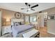 Main bedroom with ceiling fan, white dresser, and access to bathroom at 452 Cerromar Rd # 176, Venice, FL 34293