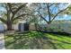 Landscaped backyard with storage shed and large oak trees at 4822 30Th Street E Ct, Bradenton, FL 34203