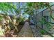 Pathway through a lush, tropical backyard garden at 4822 30Th Street E Ct, Bradenton, FL 34203