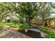 Landscaped backyard with a stone path and a wooden bench at 4822 30Th Street E Ct, Bradenton, FL 34203