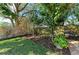 Landscaped backyard featuring a variety of plants and trees at 4822 30Th Street E Ct, Bradenton, FL 34203