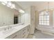 Bathroom features double vanity, large mirror, and soaking tub at 4822 30Th Street E Ct, Bradenton, FL 34203