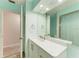 Light teal bathroom with quartz countertop and white cabinets at 4822 30Th Street E Ct, Bradenton, FL 34203