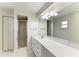 Bright bathroom features a vanity with ample counter space, shower stall, and large mirror at 4822 30Th Street E Ct, Bradenton, FL 34203