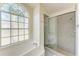 Bathroom with shower/tub combo, tile flooring, and large window at 4822 30Th Street E Ct, Bradenton, FL 34203