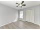 Bedroom with ceiling fan, wood-look flooring, and double door closet at 4822 30Th Street E Ct, Bradenton, FL 34203