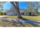 Single-story house with a large tree in the front yard at 4822 30Th Street E Ct, Bradenton, FL 34203