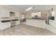 Kitchen boasts an island, white cabinets, and modern appliances at 4822 30Th Street E Ct, Bradenton, FL 34203