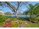 Landscaped backyard with lake view at 4850 Sweetshade Dr, Sarasota, FL 34241