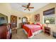 Bedroom with a queen bed, ceiling fan, and built-in shelving at 4850 Sweetshade Dr, Sarasota, FL 34241