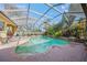 Freeform pool with screened enclosure and brick pavers at 4850 Sweetshade Dr, Sarasota, FL 34241