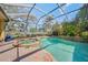 Screened pool and spa with lush landscaping at 4850 Sweetshade Dr, Sarasota, FL 34241