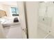 Bright bathroom with a walk-in shower and bedroom view at 4950 Remington Dr # 208, Sarasota, FL 34234