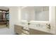 Modern bathroom with double vanity, marble countertops, and a walk-in shower at 4950 Remington Dr # 208, Sarasota, FL 34234